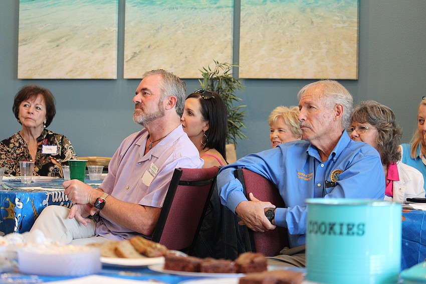 Longboat Island Chapel Rev. Brock Patterson and Town of Longboat Key Town Manager Howard Tipton listen intently as Shirley Pearson shares some of the success stories from Mt. Carmel Resource Center at the June 16 Gather and Give drive.