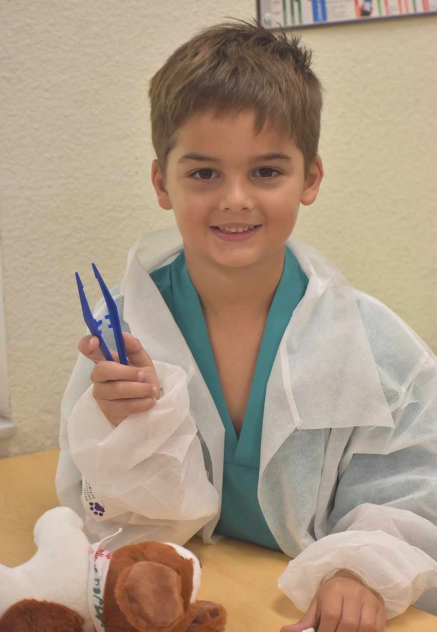 Cooper Heim, a rising first grader at Gilbert W. McNeal Elementary, attends the Little Vet School camp in full scrubs ready to learn June 18.