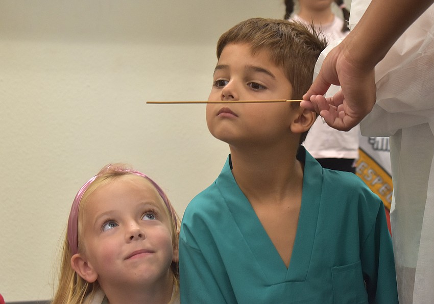 Emery Arrington, a rising first grader at Lake Manatee K-8, and Cooper Heim, a rising first grader at Gilbert W. McNeal Elementary, take turns sniffing incense in order to use their sense of smell to locate things similar to the way dogs would.