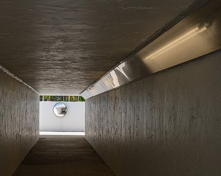 The pedestrian tunnel under State Road 789, locally known as Gulf of Mexico Drive, is illuminated by fluorescent lights.