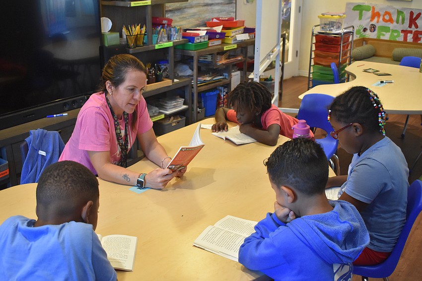 Natalia Pal reads to a group of students in a book club at Star Lab.