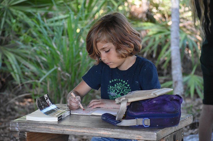 Third grader Henley Kennedy works on an assignment at Mangrove School of Sarasota.