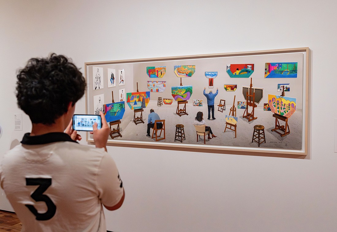 A visitor to Sarasota Art Museum takes a photo of David Hockney's "Inside It Opens Up As Well," which collector Stanton Storer loaned to the museum for "Something Borrowed, Something New."