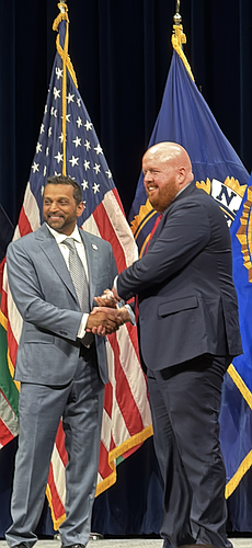 FBI Director Kash Patel presents Bunnell Police Lt. Shane Groth with his graduation certificate during the 298th Session of the FBI National Academy in Quantico, Virginia. Groth is the first member of the Bunnell Police Department to complete the prestigious program. Courtesy of the Bunnell Police Department.