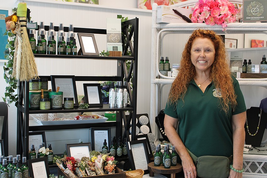 Tryla Brown Larson introduces Summer Night Out attendees to her Herb Methodology booth at Design2000.