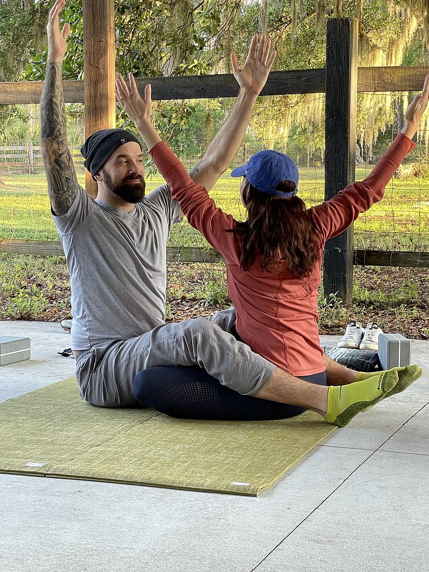 Tito and Kerri Vargas practice yoga at a couples retreat.