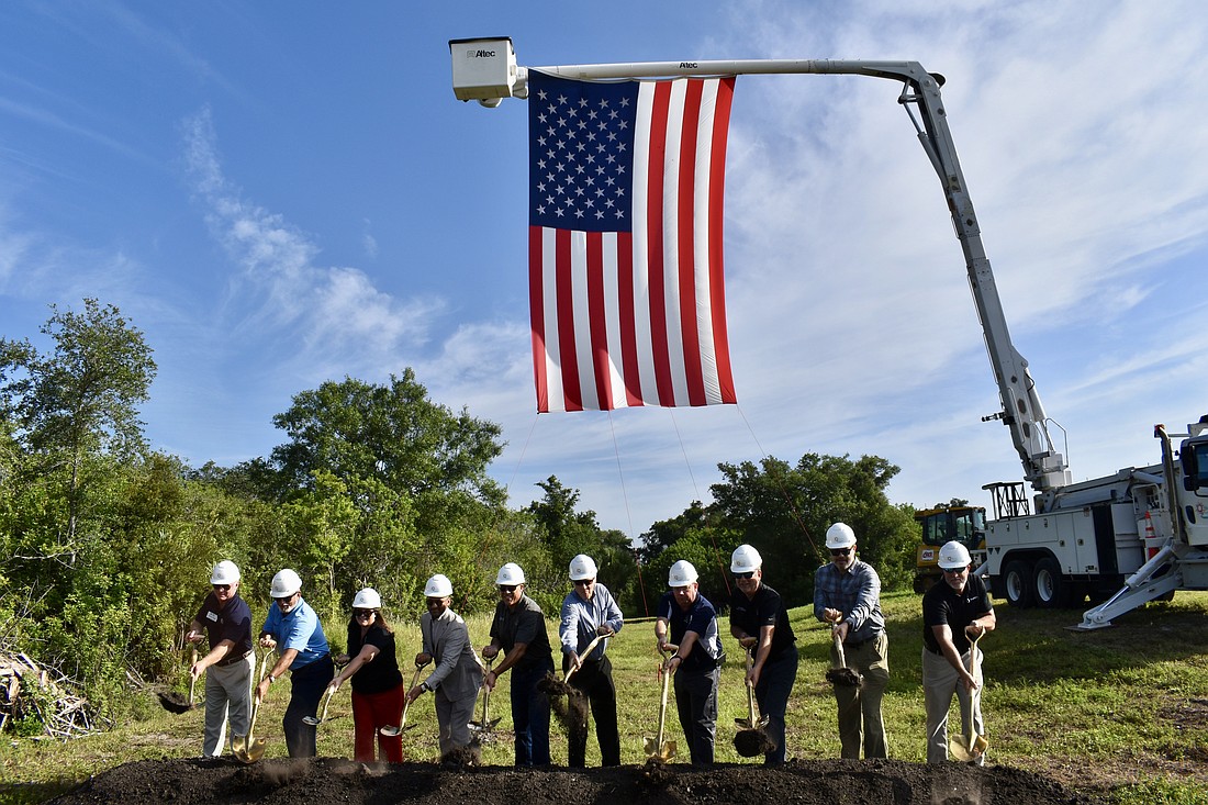 Manatee County staff and key stakeholders toss ceremonial dirt to kick off construction on a half-mile trail segment that will span from the Lake Manatee Water Treatment Plant to Rye Preserver.