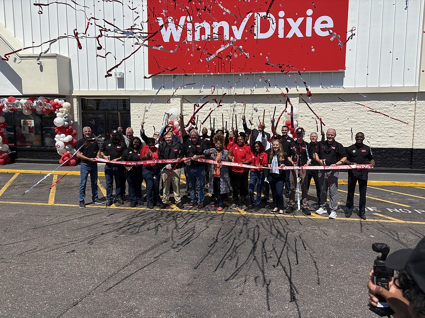 Winn-Dixie employees and executives celebrate the opening of a store at 201 W. 48th St. on June 20. Jacksonville City Council member Ju'Coby Pittman, whose District 10 includes the Brentwood-area store is at the center of the photo.