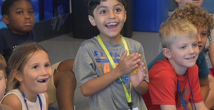 Lakeview Elementary first graders Emory Snyder, Lenny Collazo-Leon and Cullan Peacock watch in excitement to see whether items float or sink in the Ocean Technology Lab at Mote Sea May 7.