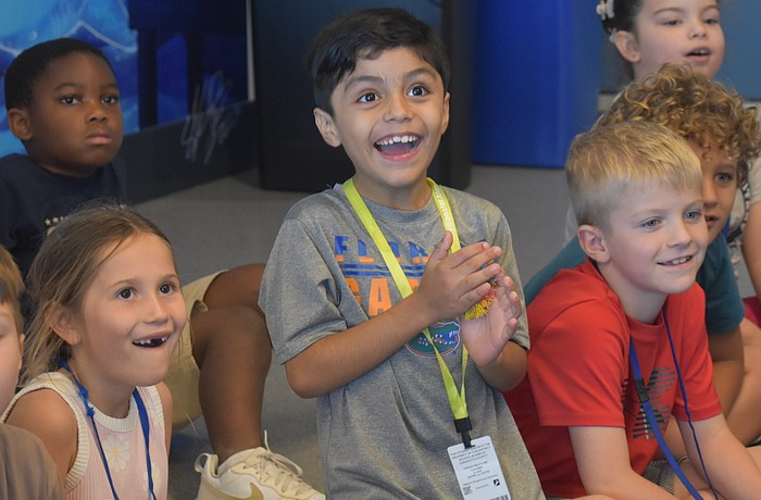 Lakeview Elementary first graders Emory Snyder, Lenny Collazo-Leon and Cullan Peacock watch in excitement to see whether items float or sink in the Ocean Technology Lab at Mote Sea May 7.