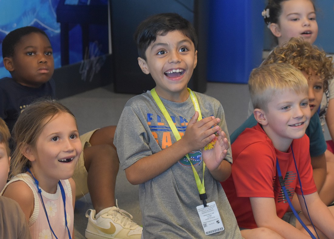 Lakeview Elementary first graders Emory Snyder, Lenny Collazo-Leon and Cullan Peacock watch in excitement to see whether items float or sink in the Ocean Technology Lab at Mote Sea May 7.