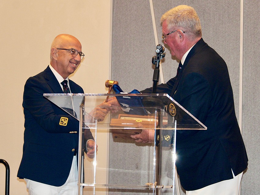 Saul Landesberg officially accepts the gavel from outgoing Commodore Tony Britt at the change of watch ceremony on June 20.