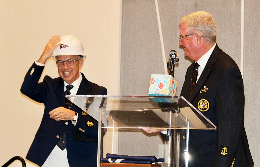 New Commodore Saul Landesberg dons the Bird Key-branded hard hat gifted to him by outgoing Commodore Tony Britt as a symbol of good luck for overseeing the final stages of the clubhouse construction.
