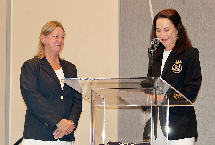 Former Bird Key Yacht Club Commodore Lisa Adams swears in new Board Governor Donna Hillmyer at the Bird Key Yacht Club change of watch ceremony.