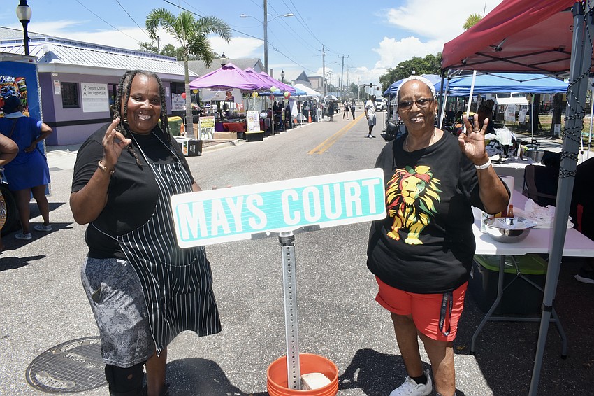 Tina Caldwell and Brenda Mays stand by the sign of Mays Court, a now-demolished residence in Newtown that was established by Brenda Mays' family, who she says are some of the first settlers in Sarasota's original Black community of Overtown.