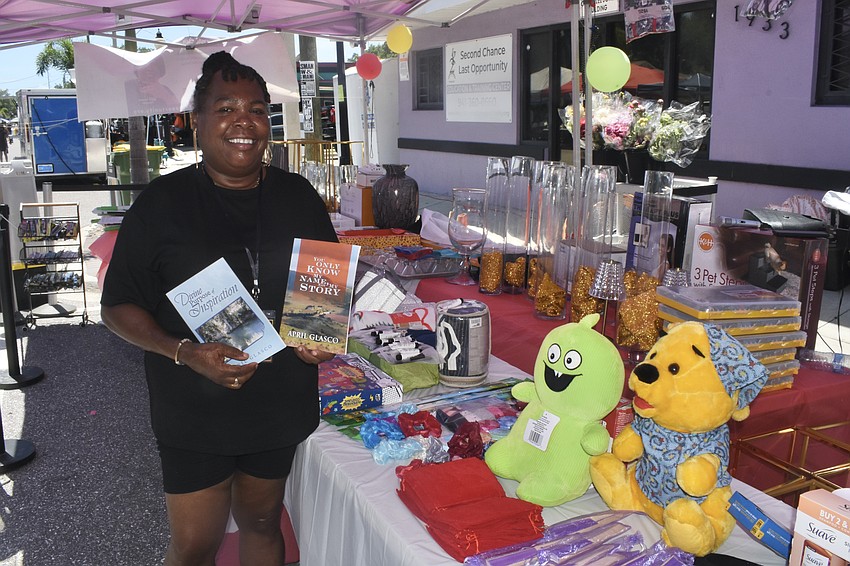 April Glasco, founder of Second Chance Last Opportunity, holds some of her books.