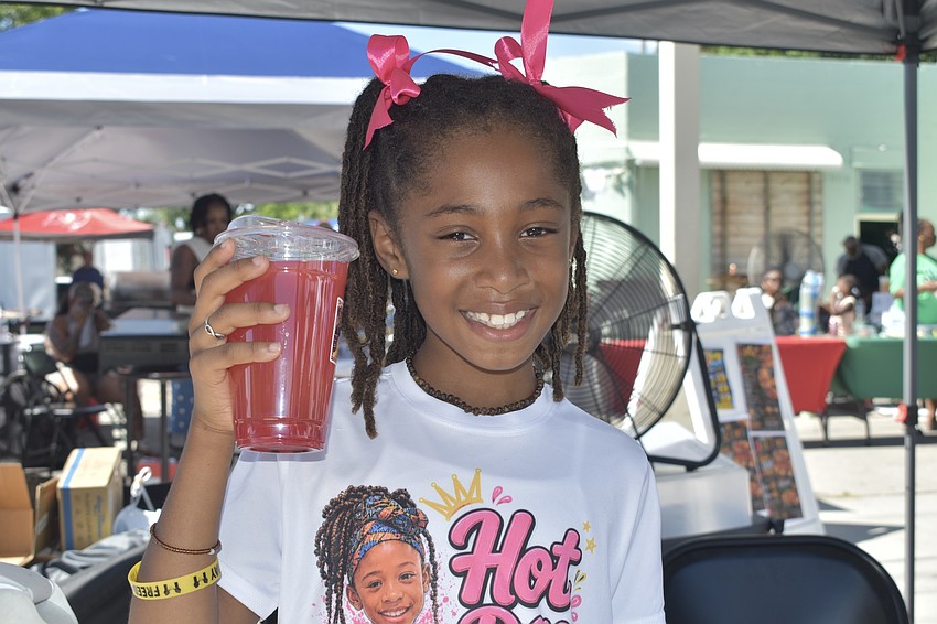 Tegan Salem, 8, works the counter at Hot Day Juice Stand.