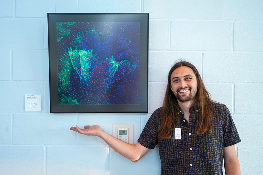 Graduate student Cody Miner displays his artwork. Photo by Rachel Mills Graduate student Cody Miner displays his artwork. Photo by Rachel Mills