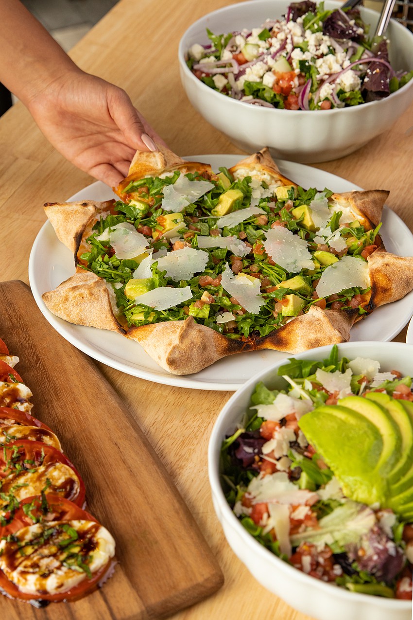 Pizza, salads and a burrata bar are on the menu at the pizzeria's UTC location. Pizza, salads and a burrata bar are on the menu at the pizzeria's UTC location.