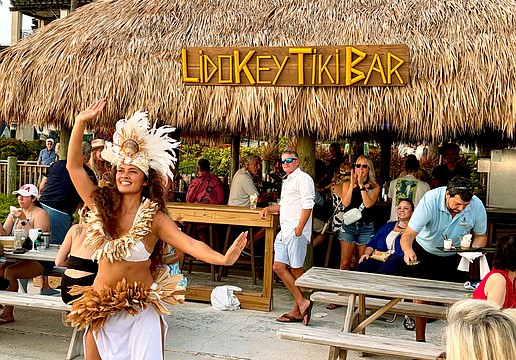 Kelera Turaga, a dancer with GRAE Productions, performs at sunset for The Ritz-Carlton's reopening celebrations for the Lido Key Tiki Bar on June 20. After a year-and-a-half rebuilding process, the beachside bar is now open to the public.