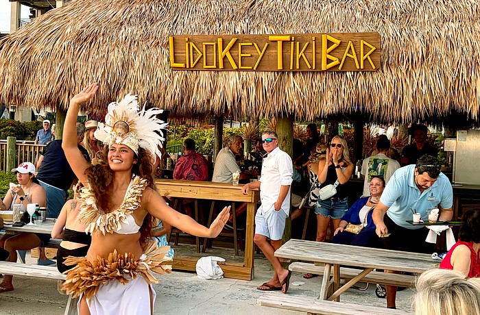 Kelera Turaga, a dancer with GRAE Productions, performs at sunset for The Ritz-Carlton's reopening celebrations for the Lido Key Tiki Bar on June 20. After a year-and-a-half rebuilding process, the beachside bar is now open to the public.
