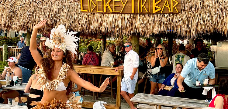 Kelera Turaga, a dancer with GRAE Productions, performs at sunset for The Ritz-Carlton's reopening celebrations for the Lido Key Tiki Bar on June 20. After a year-and-a-half rebuilding process, the beachside bar is now open to the public.