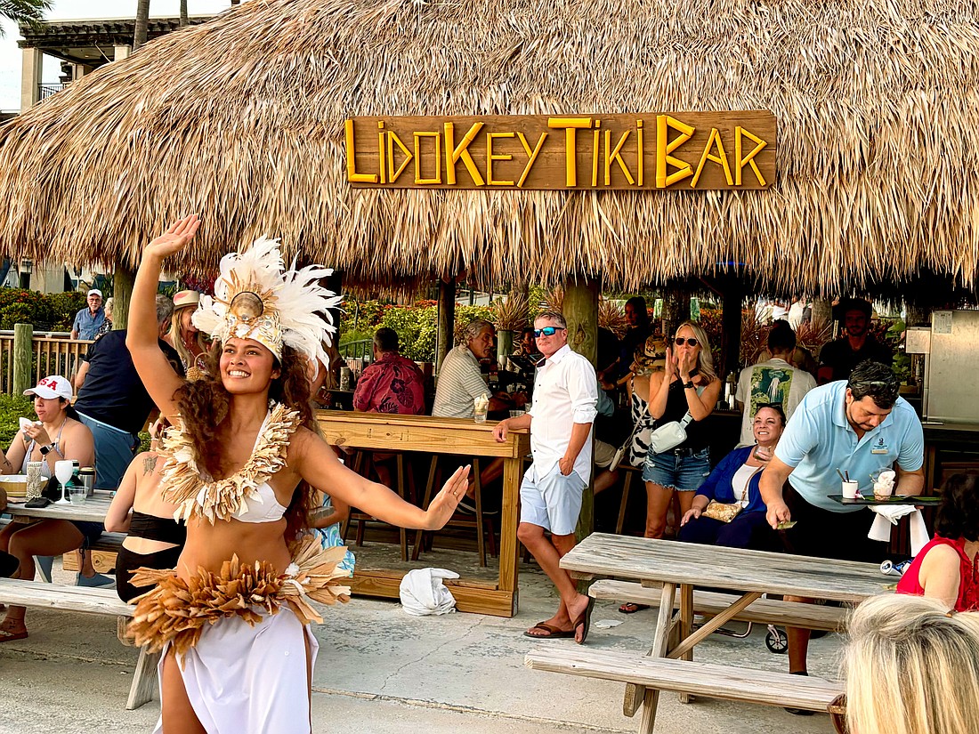 Kelera Turaga, a dancer with GRAE Productions, performs at sunset for The Ritz-Carlton's reopening celebrations for the Lido Key Tiki Bar on June 20. After a year-and-a-half rebuilding process, the beachside bar is now open to the public.