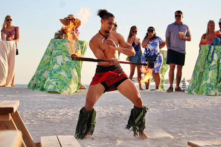 Performer Adam Netane brings the heat at the grand reopening of the Lido Key Tiki Bar.