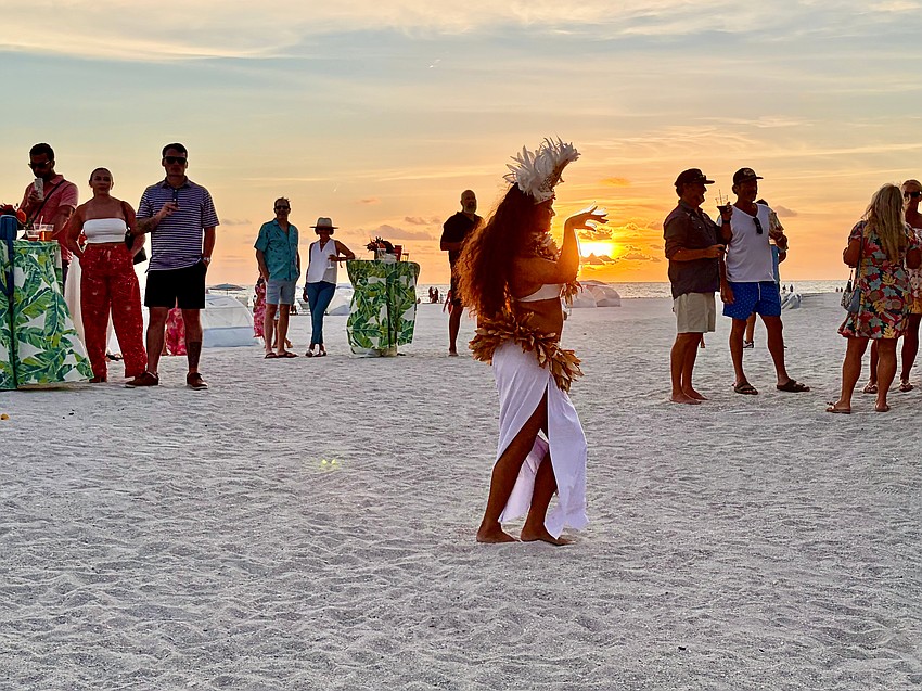 As the sun sets over Lido Beach, dancer Kelera Turaga seems to nearly pluck it from the sky.