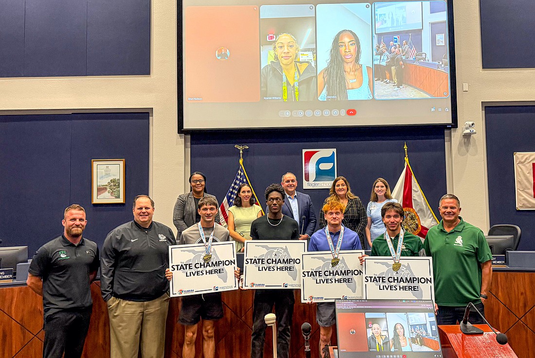 Flagler Palm Coast's 4x400-meter state champion track relay team was honored at the Flagler County School Board meeting on June 23 along with state champs Nya Williams (weightlifting) and Karina Marcelus (track and field triple jump) who joined remotely. From left: FPC Principal Bobby Bossardet, athletic director Scott Drabczyk, state 4x400 champs Logan Jacobelli, Jordan Haymon, Mike Najpaver and Will Roberts and track coach David Halliday. Courtesy photo