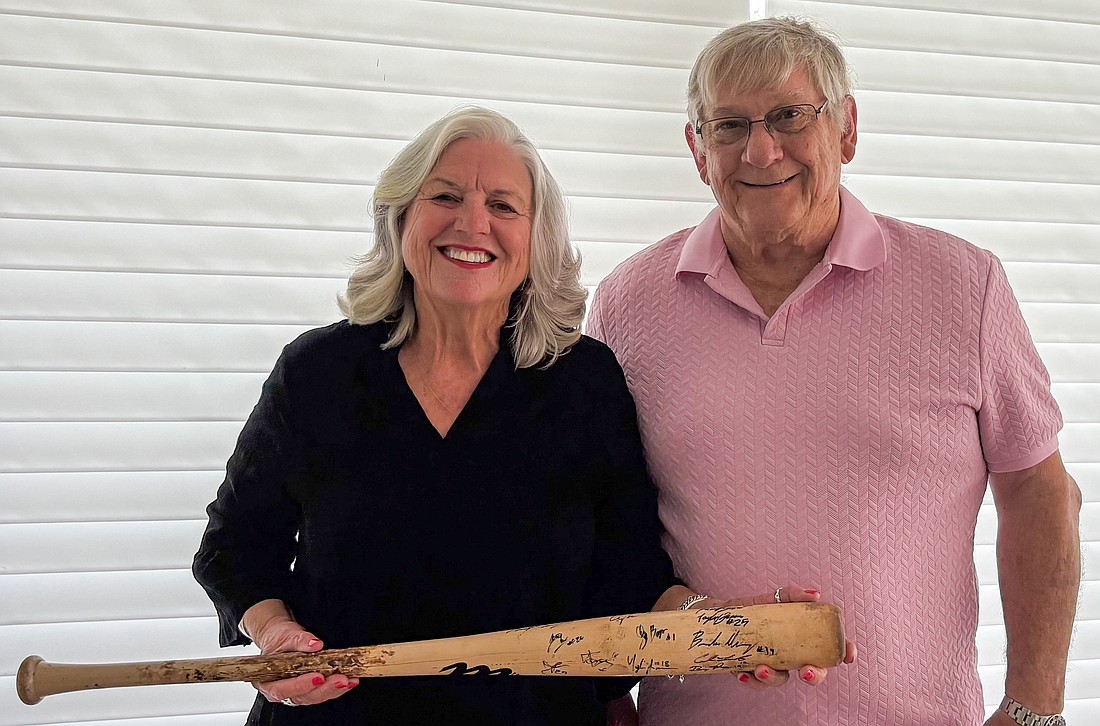 Karen and Jerry Faye were given a signed broken wooden baseball bat from one of the Winter Garden Squeeze players they hosted years ago.