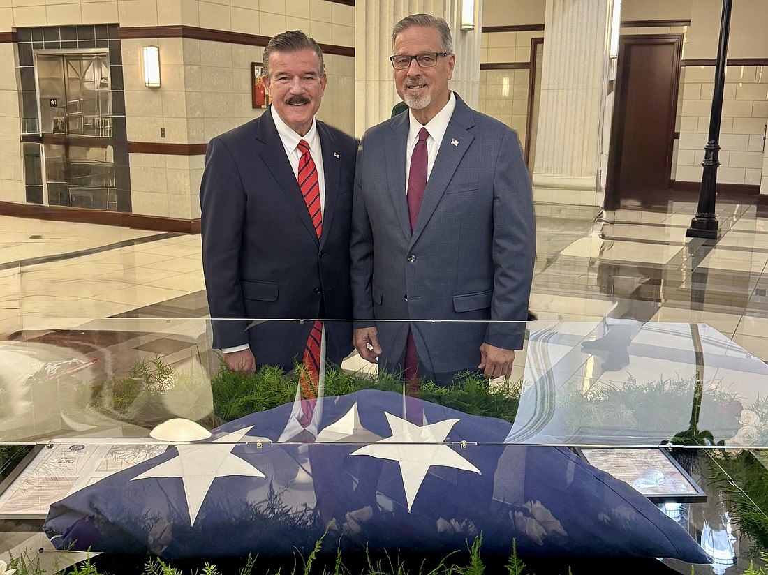 Fourth Judicial Circuit Chief Judge Lance Day, left, and Duval County Clerk of Courts Jody Phillips with the new American flag display inside the Duval County Courthouse.
