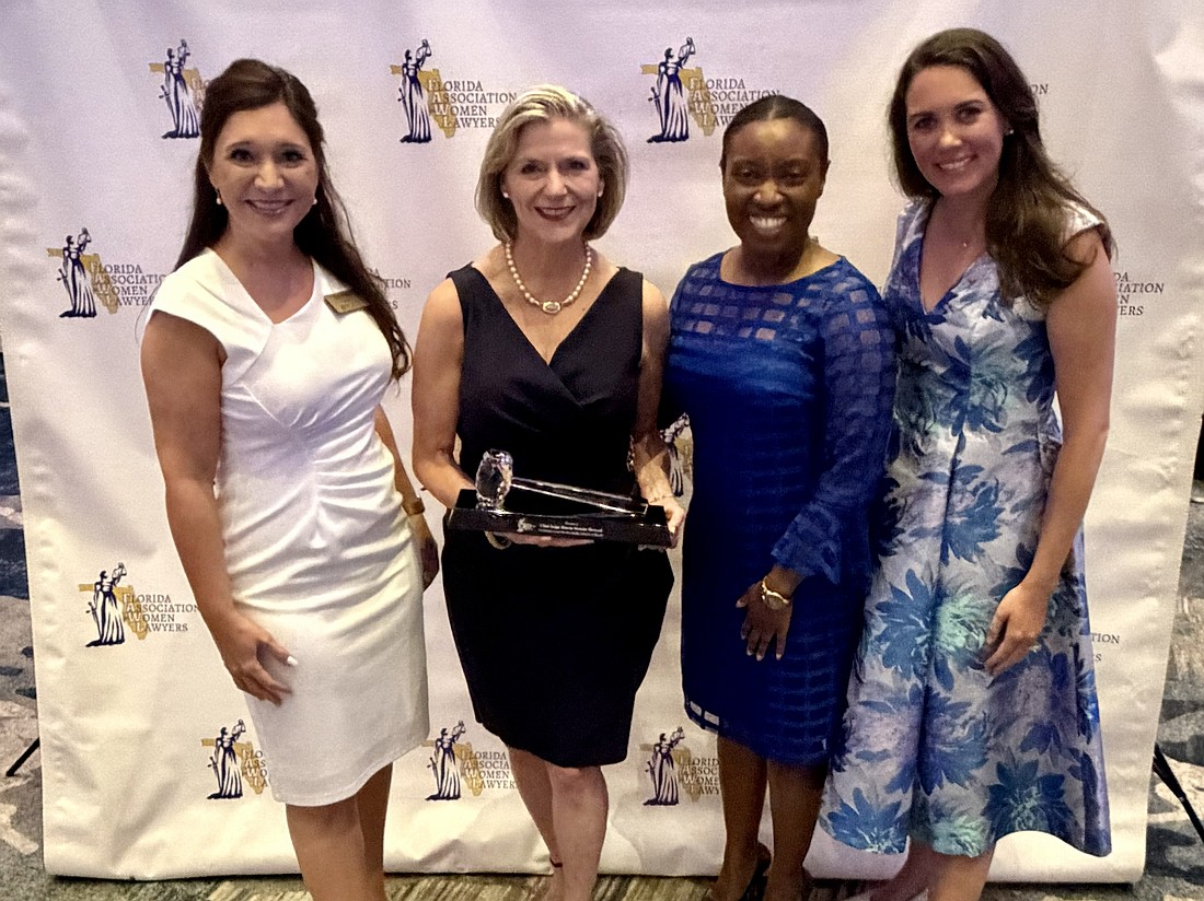 From left: Jacksonville Women Lawyers Association President-elect Sarah Morris; Chief Judge of the U.S. District Court, Middle District of Florida, Marcia Morales Howard, the Florida Association for Women Lawyers 2026 Jurist of the Year; JWLA member and 2026-27 D.W. Perkins Bar Association President Vivian Williams; and Katelyn Johnston, JWLA board member.