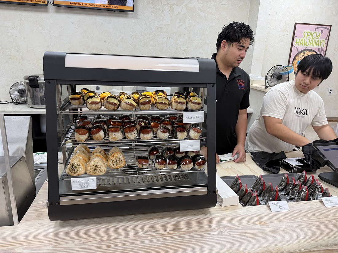 Musubi, sticky rice topped with seasoned Spam and wrapped in seaweed, sits in a case on Makai’s counter.