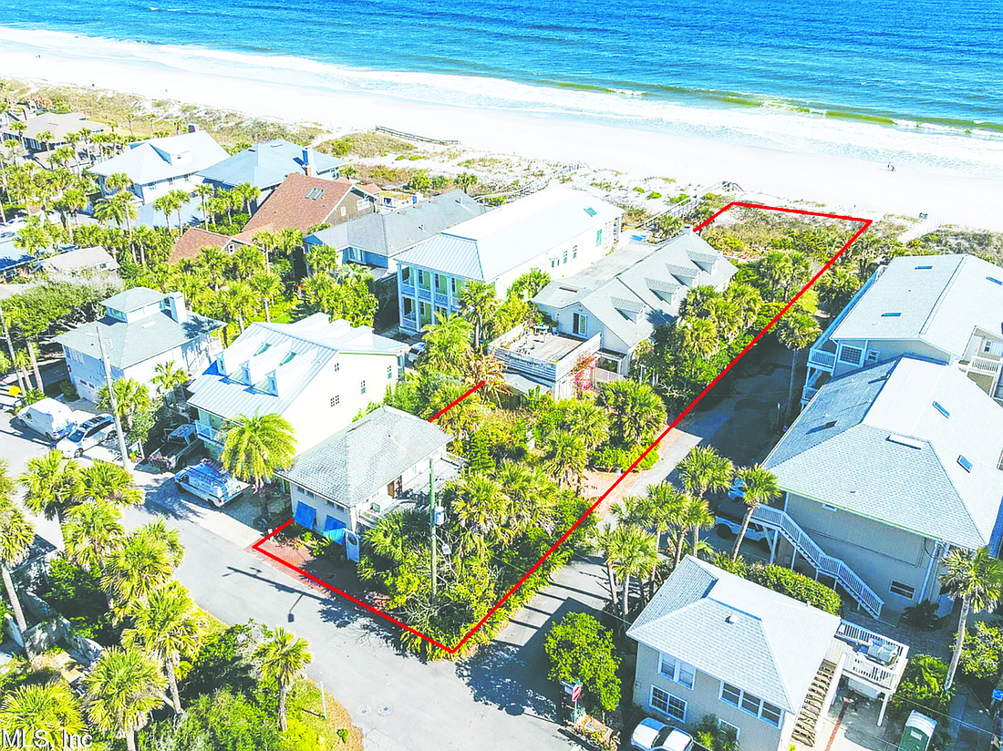 Oceanfront two-story home features five bedrooms, four full and two half-bathrooms, guesthouse, decks, porches and pool.