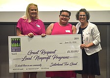 Sisterhood for Good's Glo Reber presents Harbor58's Ari Gibbons and Annie Wilson a grant for $7,500 to go towards a mentoring program for foster kids.