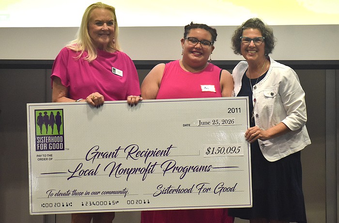 Sisterhood for Good's Glo Reber presents Harbor58's Ari Gibbons and Annie Wilson a grant for $7,500 to go towards a mentoring program for foster kids.