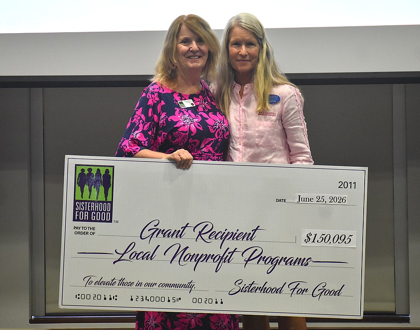 Sisterhood for Good's Amy Gorman presents a $7,500 grant for the Sarasota County Sheriff's Office Charitable Foundation to Board Member Anne Rollings.
