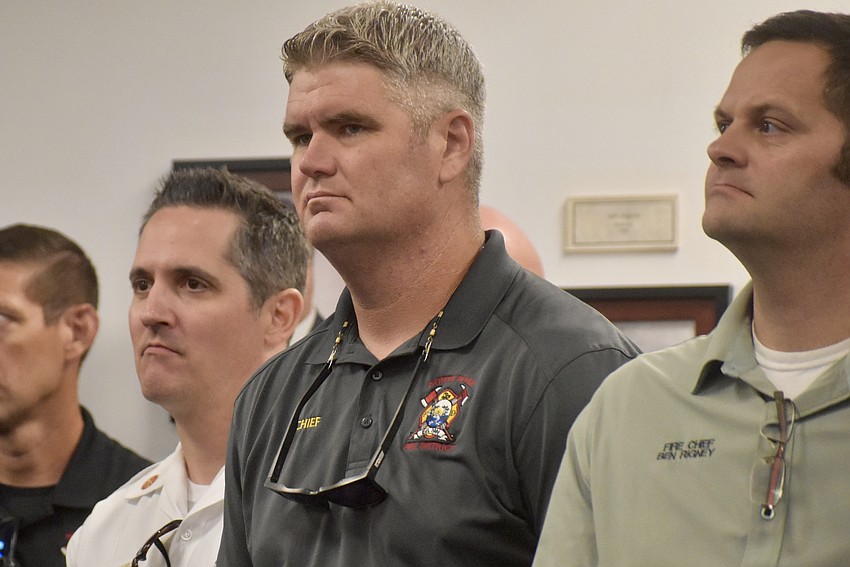 Paul Wren, future chief of East Manatee Fire Rescue, stands in the back of the commissioner chambers June 16 next to Chief Joe Sicking of North River Fire District and Chief Ben Rigney of West Manatee Fire Rescue.