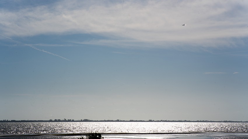 A commercial airplane traverses over Sarasota Bay before passing over Longboat Key on an outgoing flight from Sarasota-Bradenton International Airport. The town of Longboat Key commissioned a study to evaluate whether planes passing over Longboat Key were leaving black residue on the island below. A commercial airplane traverses over Sarasota Bay before passing over Longboat Key on an outgoing flight from Sarasota-Bradenton International Airport. The town of Longboat Key commissioned a study to evaluate whether planes passing over Longboat Key were leaving black residue on the island below.