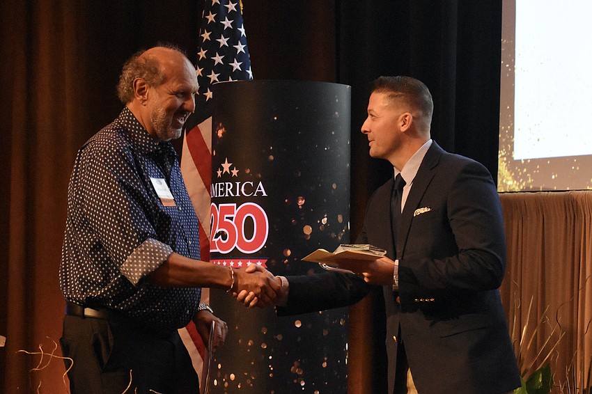 Children First CEO Philip Tavill accepts the Workforce Development & Innovation award from Josh Matlock, President and CEO of CareerSource Suncoast.