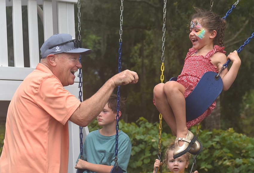 Parrish's Gary Lonczak pushes his granddaughter, 4-year-old Camilla Cruz of Lakewood Ranch, on the swing at Fiorelli Winery.