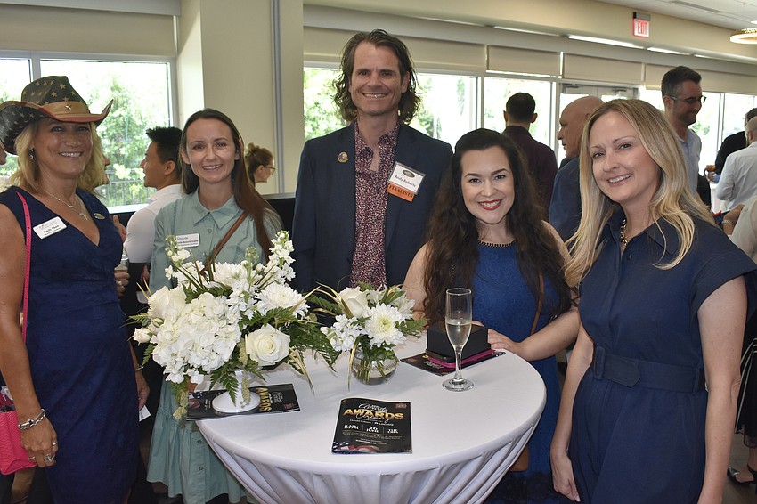 Emily Shaw, Jennifer Manzanilla Dolgetta, Andy Roberts, Olivia Turpening and Erin Duggan, president and CEO of Visit Sarasota County, gather at a table.