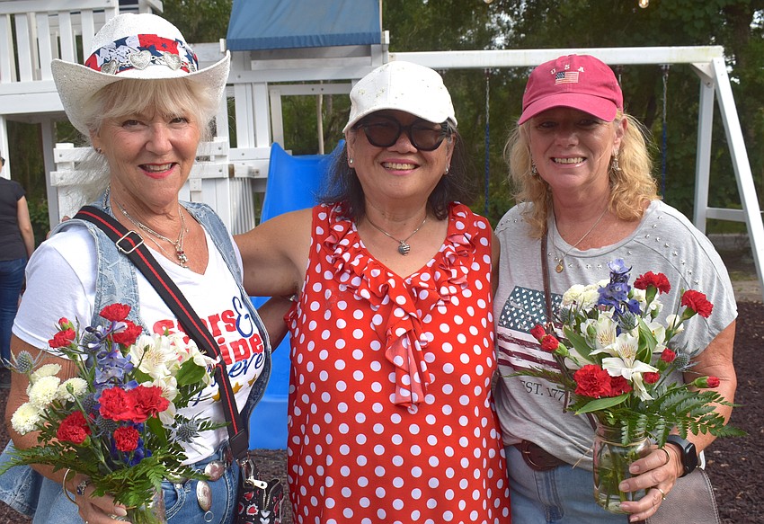 Myakka City's Beth Dadson, Jean Hurst and Beth McNett embrace the 250th anniversary of the U.S. with red, white and blue flowers from Sarasota Florists.