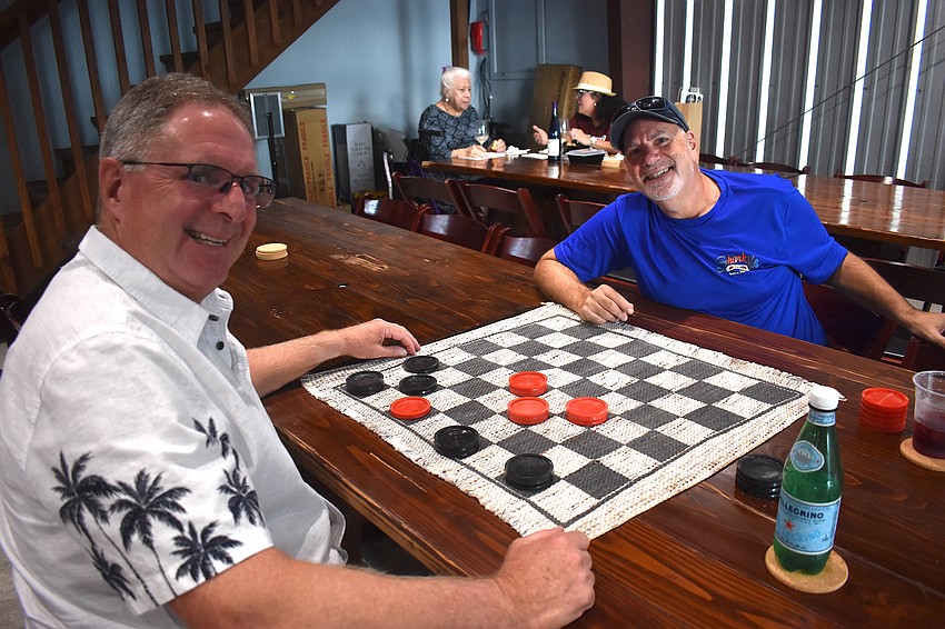 Lakewood Ranch's Tom Stanton and Dave Stroly play checkers inside the new wine tasting area at Fiorelli Winery.