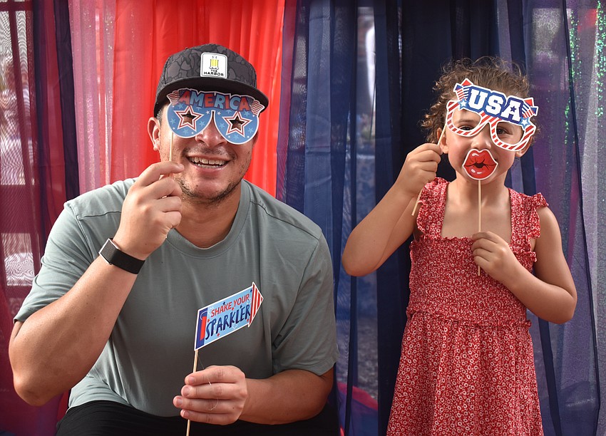 Lakewood Ranch's Nick Cruz and his daughter, 4-year-old Camilla Cruz, test out the photo booth at the Red, White and Blueberry Celebration at Fiorelli Winery.