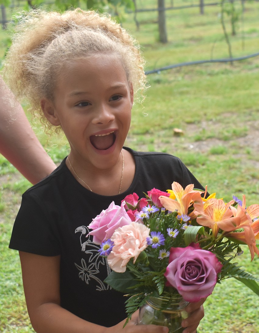 Bradenton's Addy Ungarelli, 6, couldn't hold back her excitement when she saw her finished bouquet from Sarasota Florists at the Red, White and Blueberry Celebration.