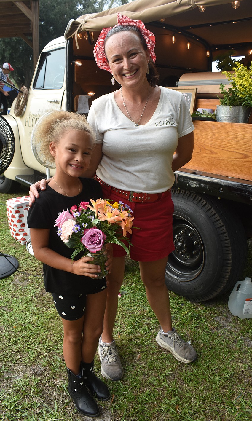 Bradenton's Addy Ungarelli, 6, gets to take home a fresh bouquet from Sarasota Florists with the help of owner Stevie Krumm.