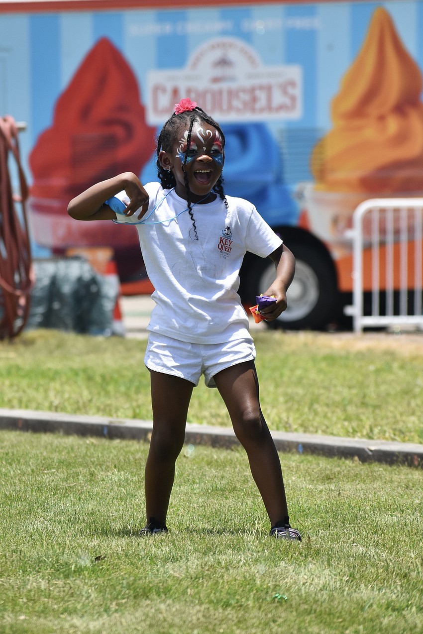 Mila McIntosh, 6, tosses a beanbag.