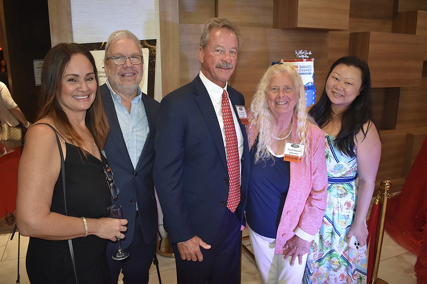 Frances Vives and her husband Jaime Vives of Vives Digital, a finalist for Woman-Owned Business of the Year; Tim Solomon and Jan Solomon of Key Sailing, a finalist for Breakthrough Business of the Year, and official America250 artist Jing Herman, gather together.